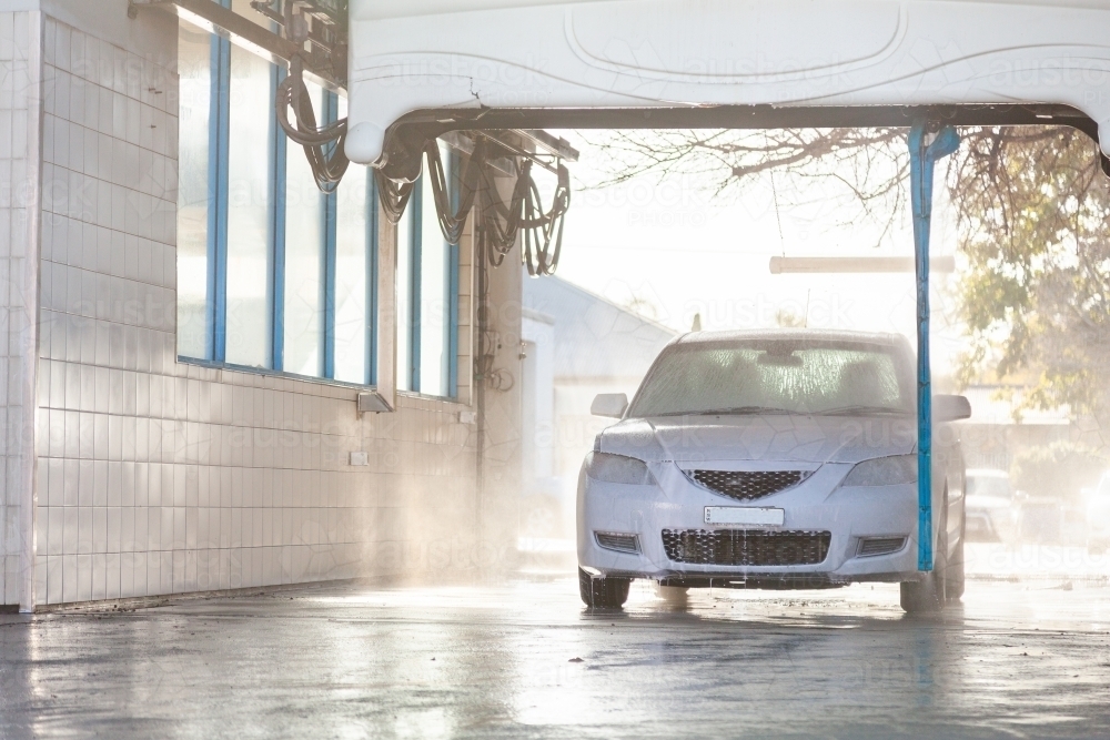 White car in automated car wash facility - Australian Stock Image