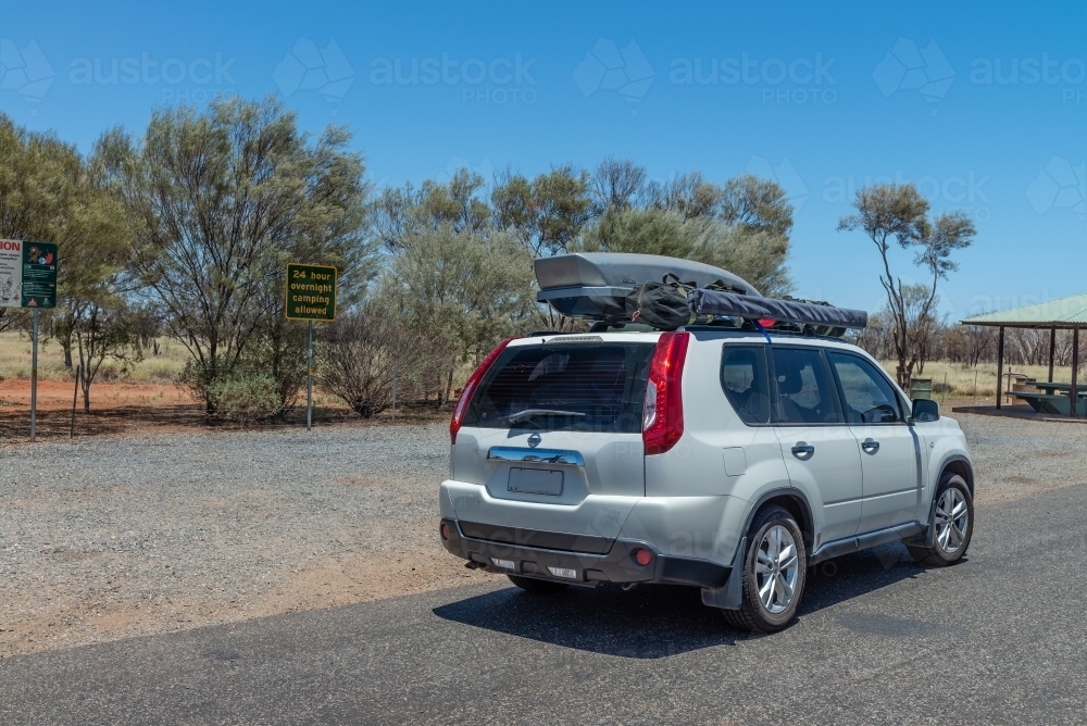 White car with pod and tent on roof - Australian Stock Image