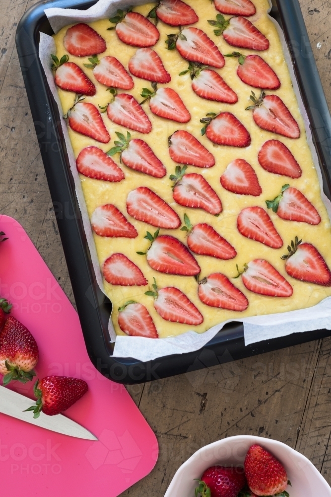 white chocolate blondie with fresh strawberries, before going into the oven - Australian Stock Image