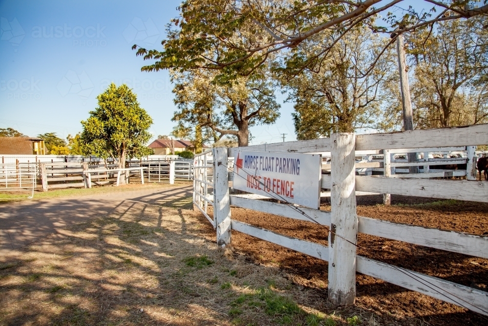 Image of White fence of cattle yards with horse float parking sign at singleton showground