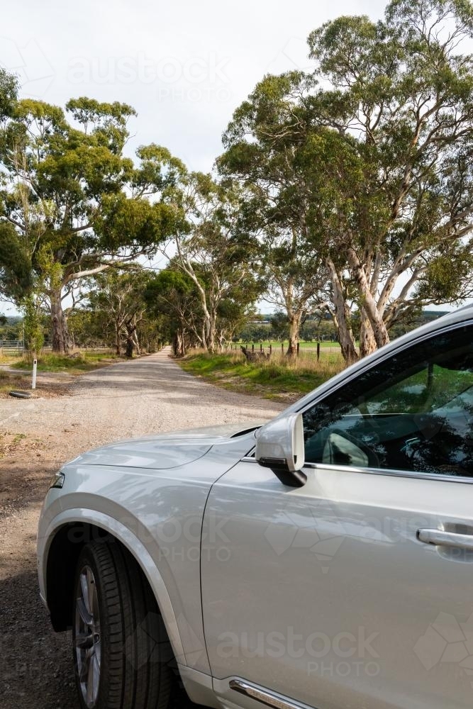 White four wheel drive vehicle on a dirt road in the country - Australian Stock Image