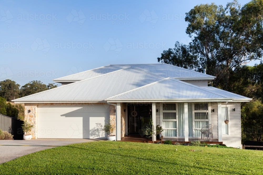 White house with front veranda and swing - Australian Stock Image