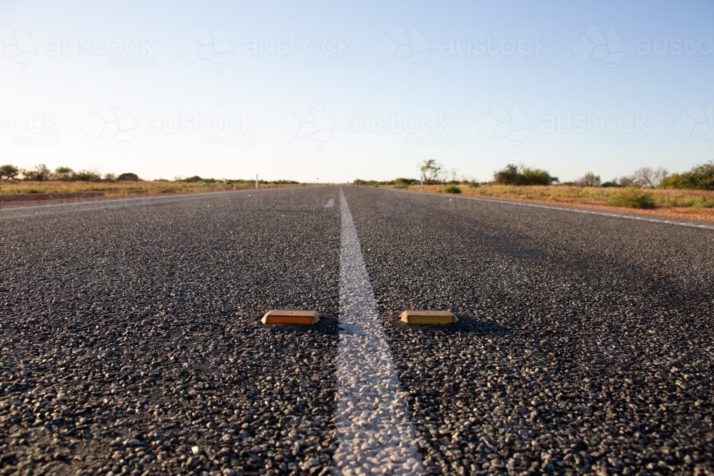 White line and cats-eye reflectors on an outback highway - Australian Stock Image
