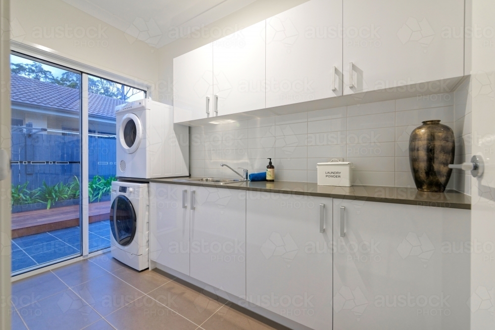 Image Of White Modern Laundry With Washing Machine And Clothes Dryer White Modern Laundry With Washing Machine And Clothes Dryer Cabinet Bench Top Australian Stock