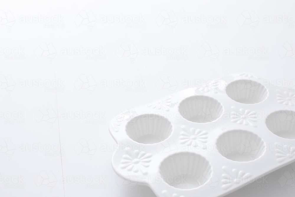 White muffin tray on blank background - Australian Stock Image