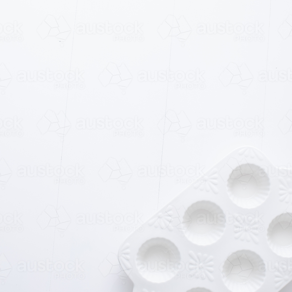 White muffin tray on blank background - Australian Stock Image