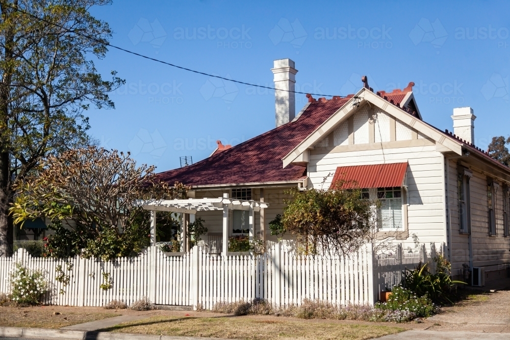 White picket fence and suburban home - Australian Stock Image