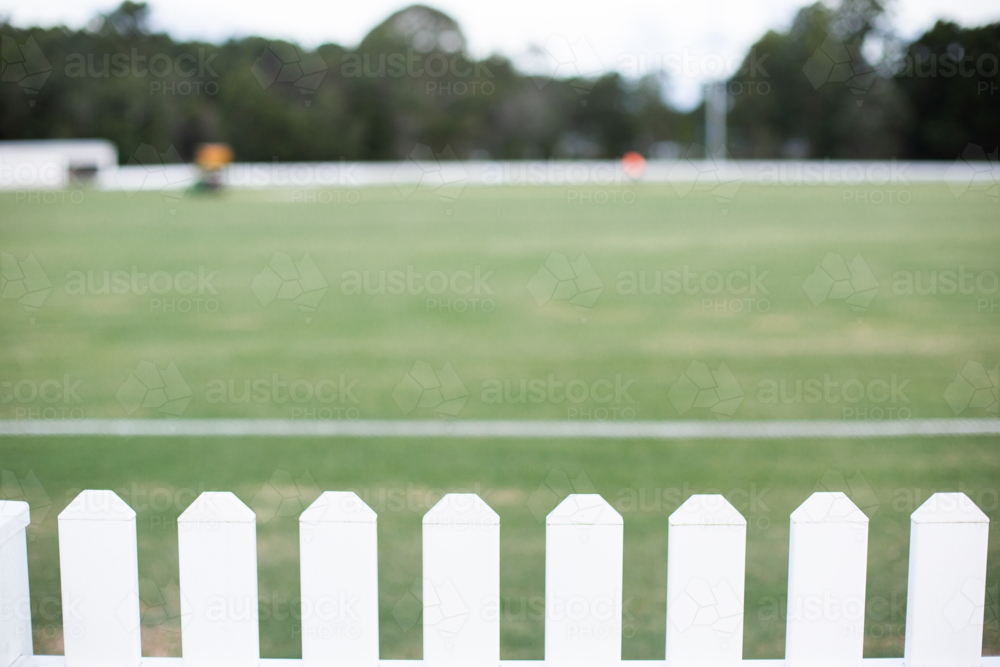 white picket fence around a local cricket field - Australian Stock Image