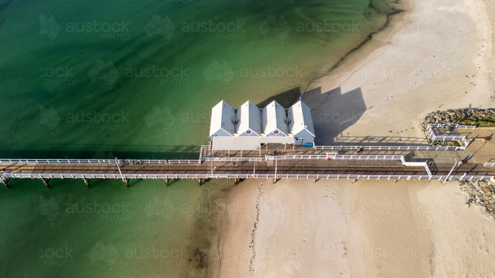 White roofed buildings perched at the start of the pier. - Australian Stock Image