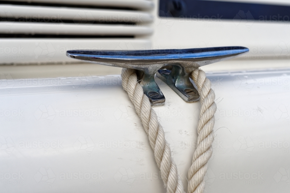 White ropes and silver cleats detail on white yacht rigging - Australian Stock Image