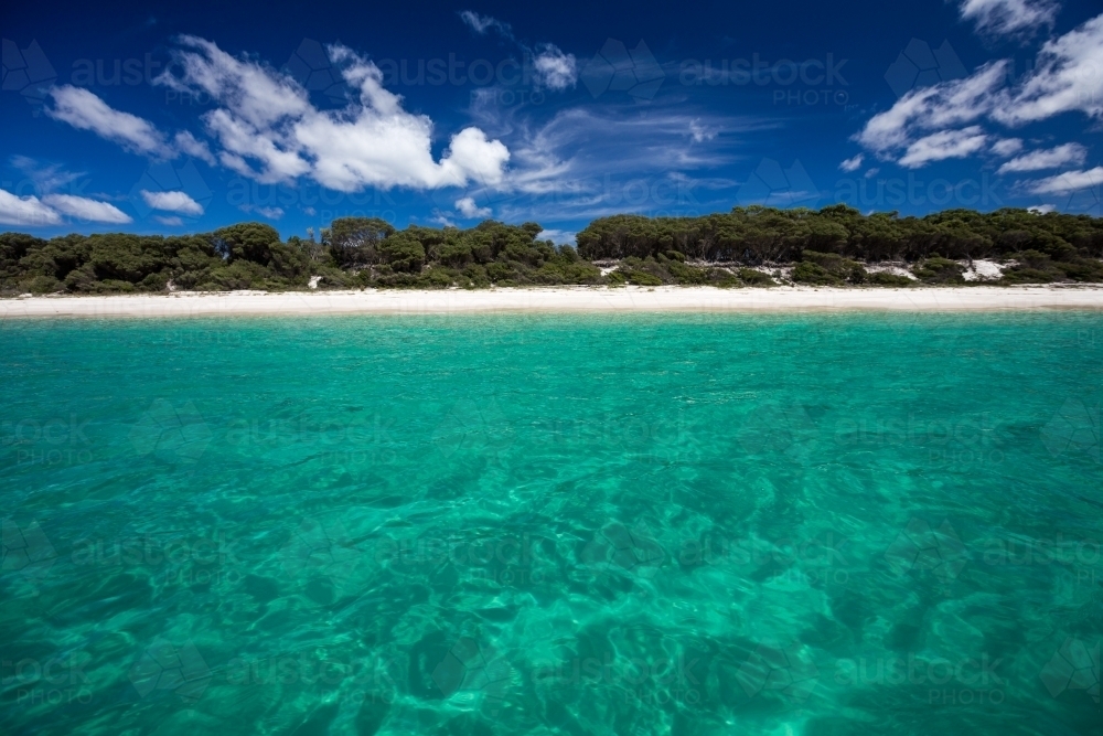 White sand beach viewed from the water - Australian Stock Image