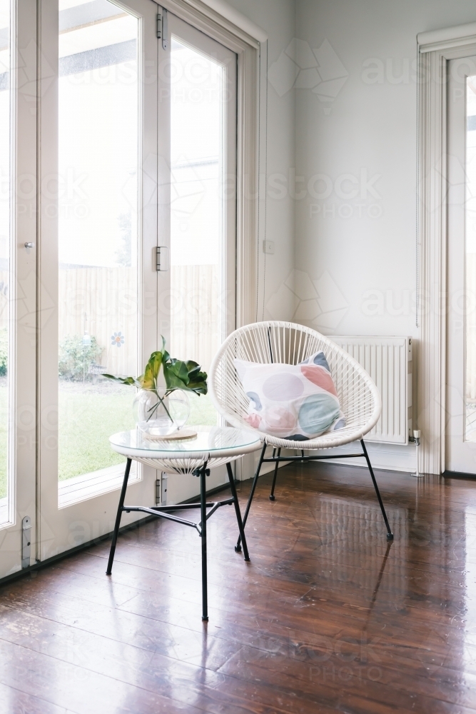 White string style occasional chair and matching side table in luxury home - Australian Stock Image