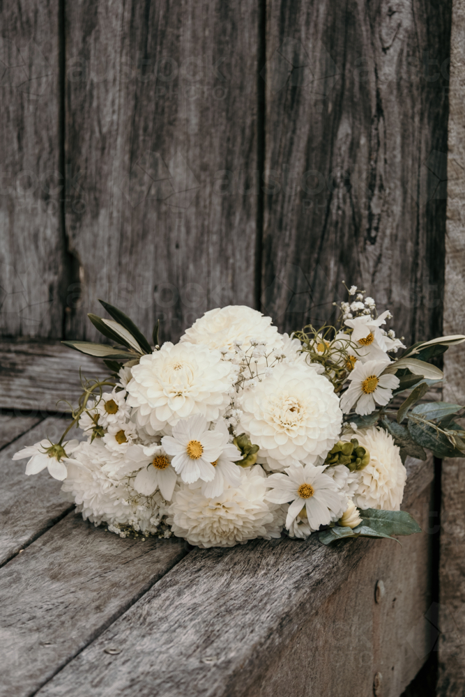 White wedding bouquet laid on decking. - Australian Stock Image