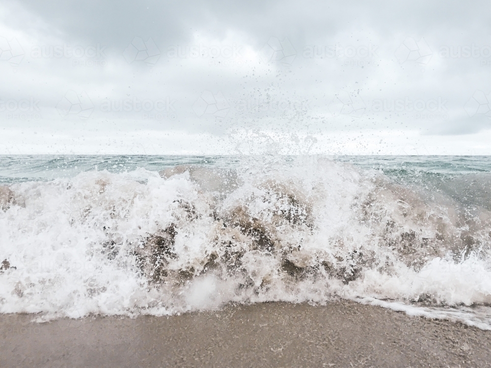 Whitewash waves crashing on the shore - Australian Stock Image