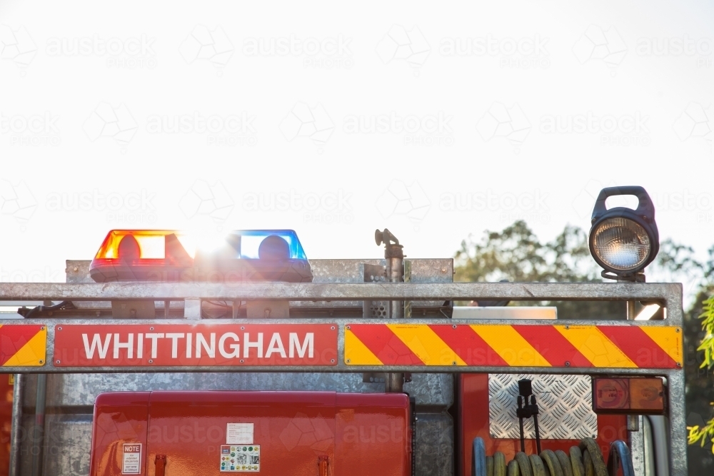 Whittingham rural fire service truck with sun flare through emergency lights - Australian Stock Image