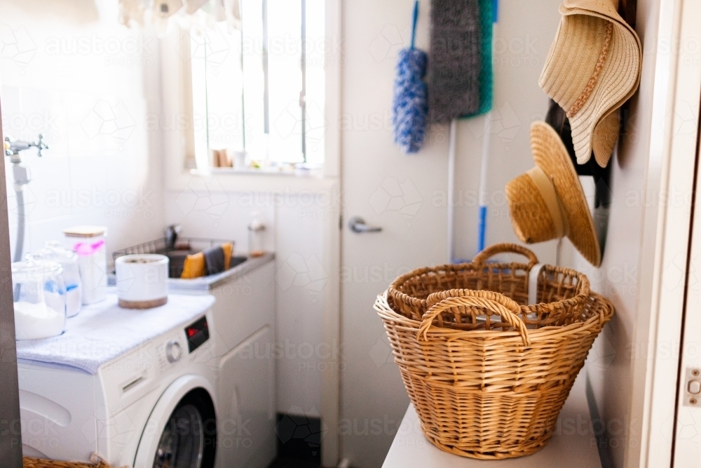 wicker basket sitting in laundry room - Australian Stock Image