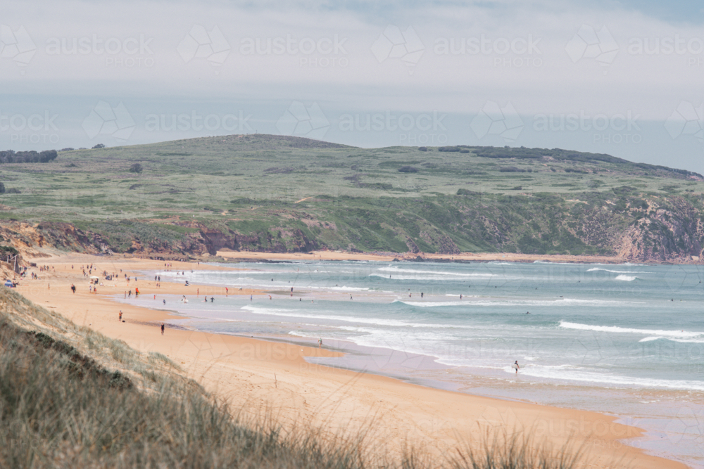 Wide shot of Cape Woolamai surf beach with cliffs in distance - Australian Stock Image