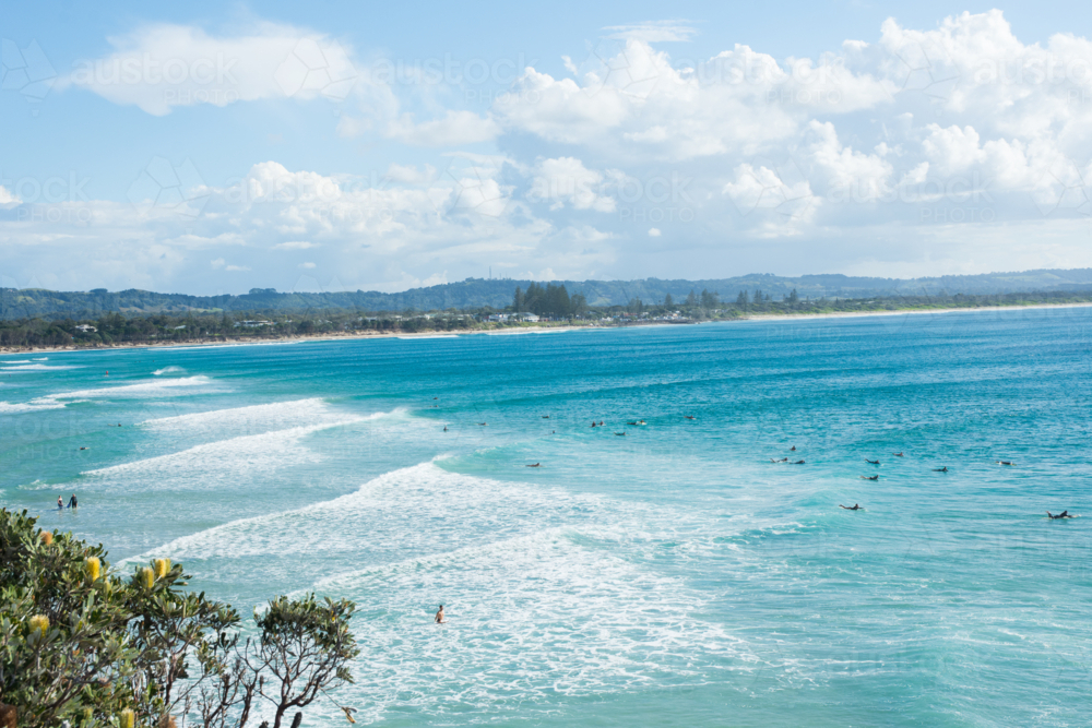 Wide shot of surfers on the water at Byron Bay - Australian Stock Image