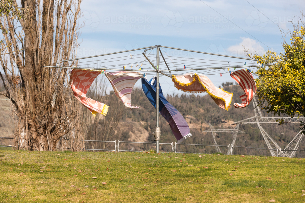 Wind blowing towels on hills hoist with Snowy Hydro in the background - Australian Stock Image