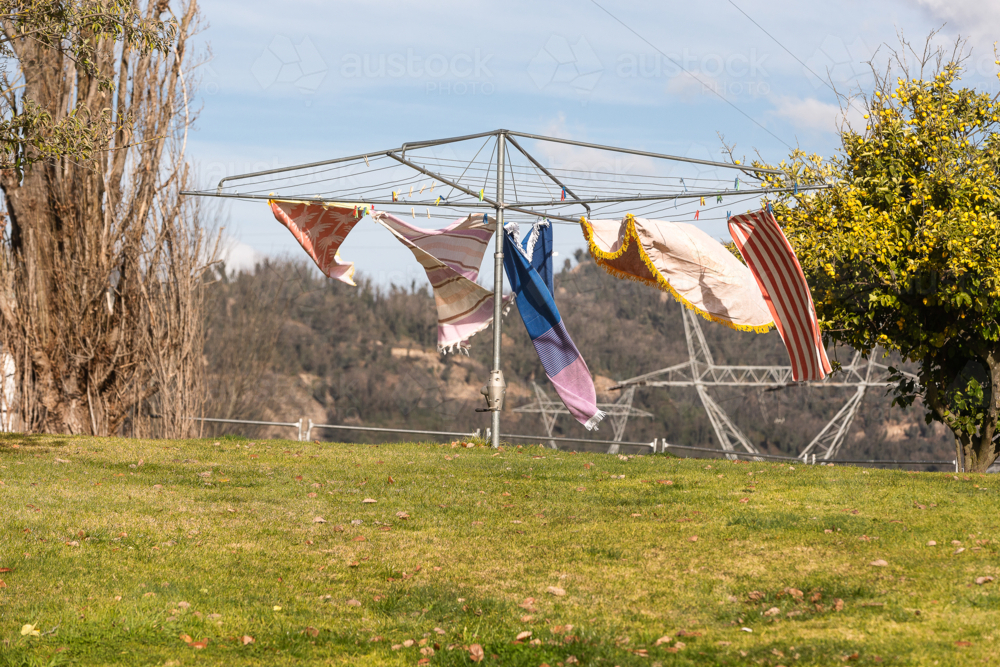Wind blowing towels on hills hoist with Snowy Hydro in the background - Australian Stock Image