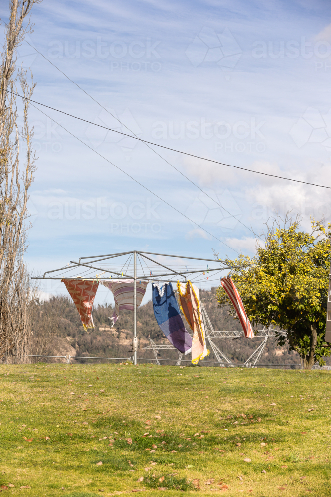 Wind blowing towels on hills hoist with Snowy Hydro in the background - Australian Stock Image