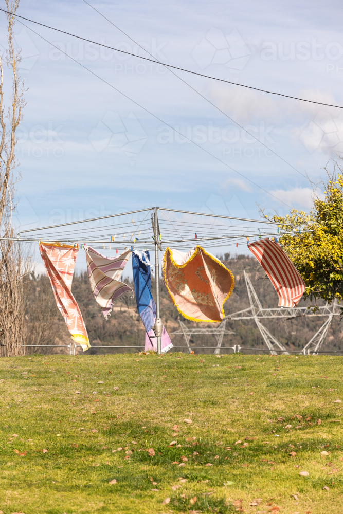 Wind blowing towels on hills hoist with Snowy Hydro in the background - Australian Stock Image