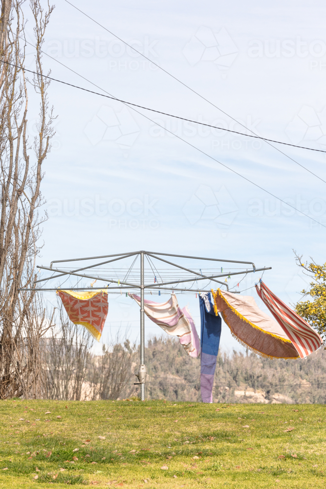 Wind blowing towels on hills hoist with Snowy Hydro in the background - Australian Stock Image