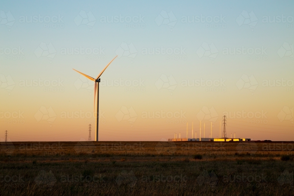 Wind turbine and battery at dusk - Australian Stock Image
