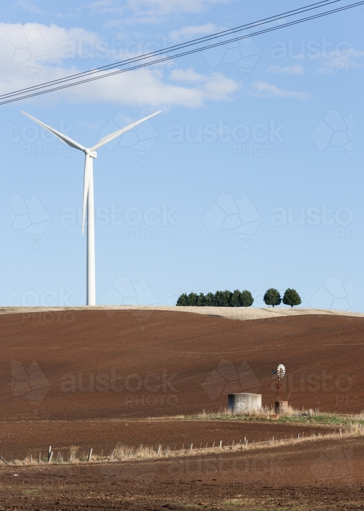 Wind turbine in paddock with windmill in foreground - Australian Stock Image