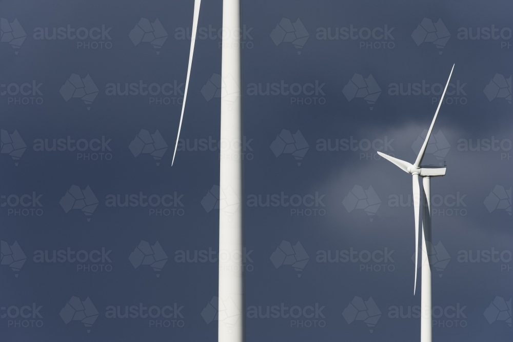 Wind turbines against a stormy sky - Australian Stock Image