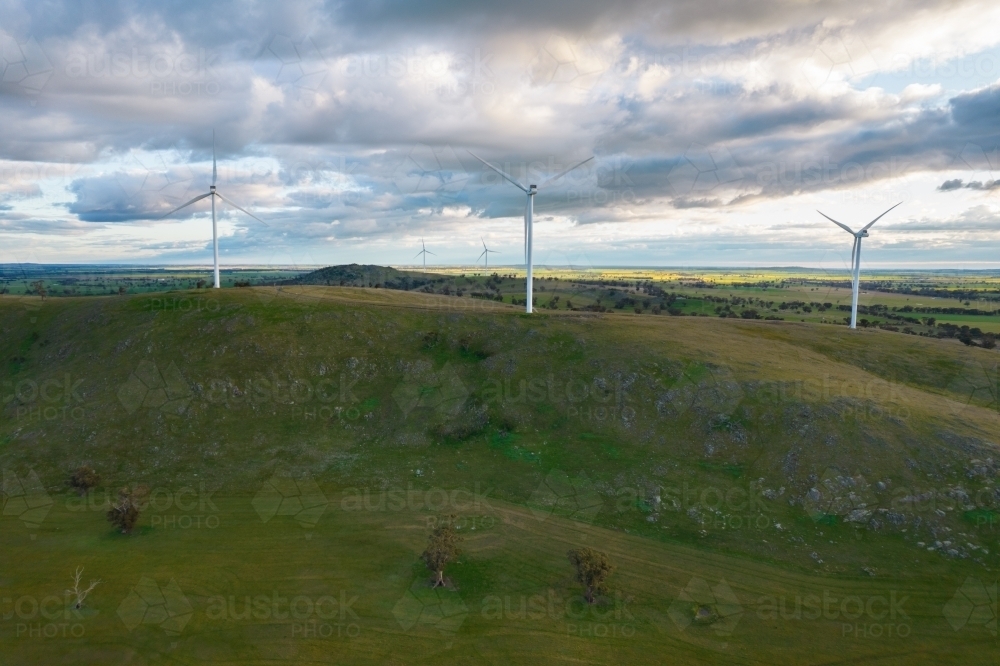 Wind turbines in a field on a cloudy day - Australian Stock Image
