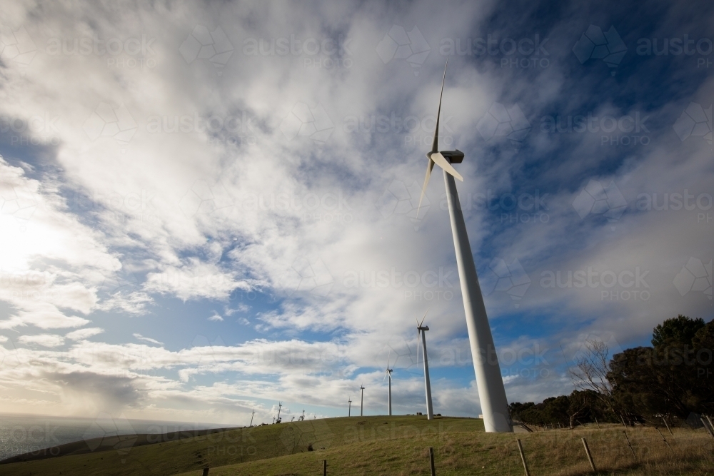Wind turbines on a bare grassy hill exposed to offshore winds on the Fleurieu Peninsula - Australian Stock Image