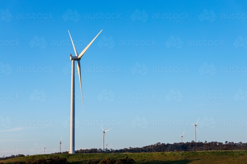 Wind turbines on scrubby hill tops - Australian Stock Image