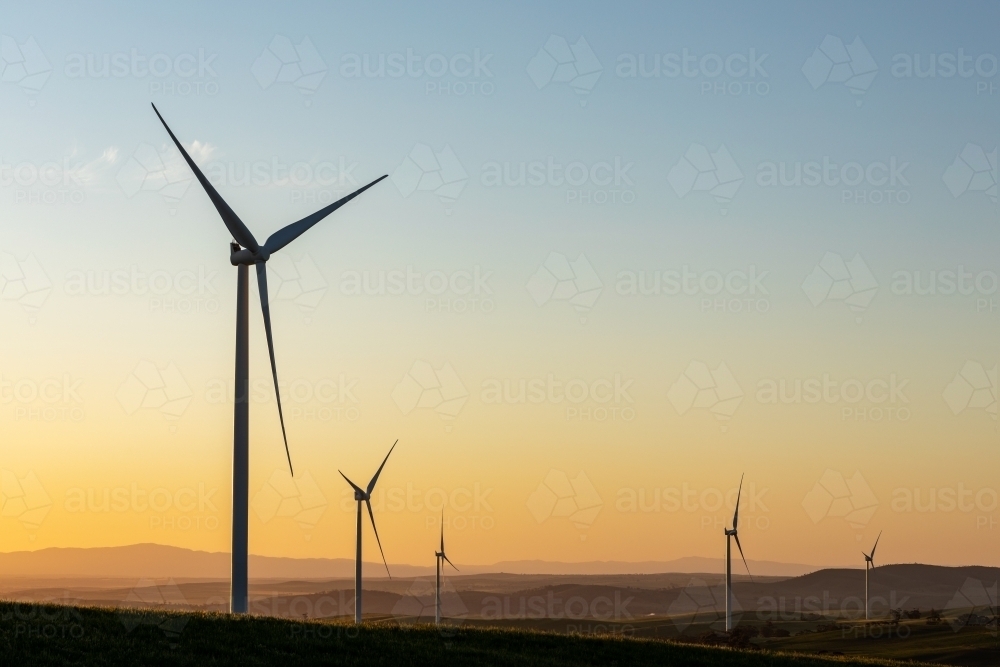wind turbines silhouetted against late afternoon sky - Australian Stock Image
