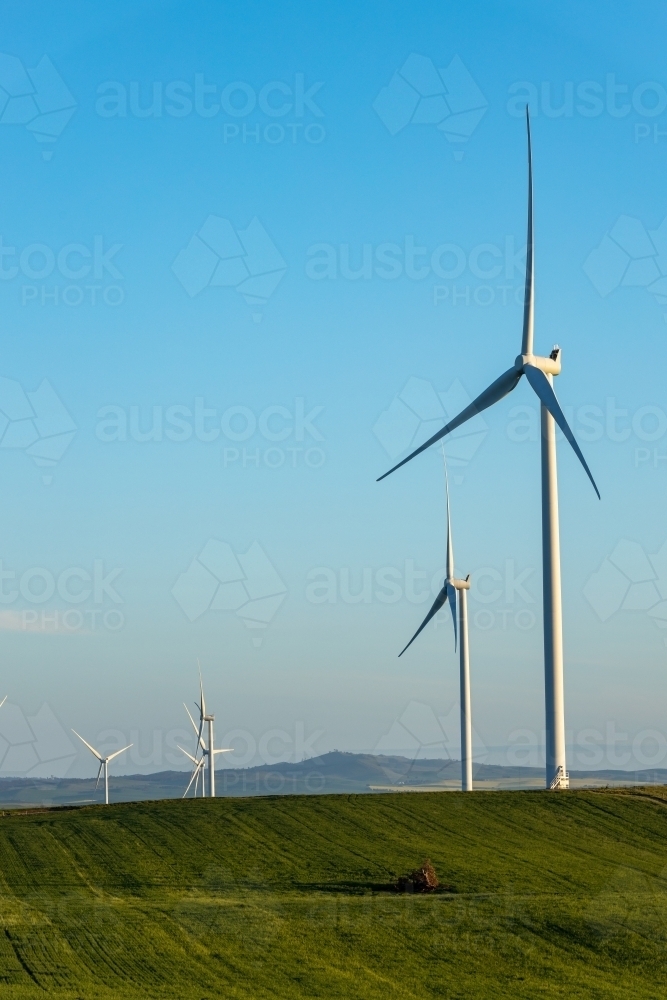 wind turbines with farmland in foreground, vertical - Australian Stock Image