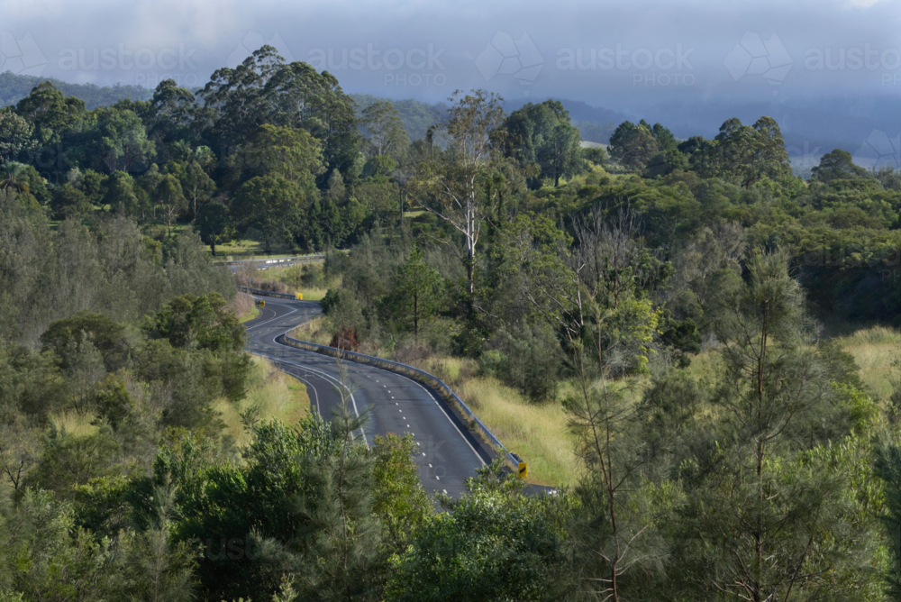 Winding country road among trees - Australian Stock Image