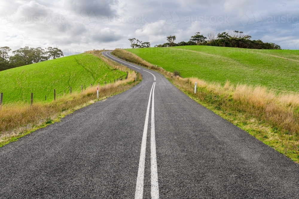 Winding road through Adelaide Hills farms during winter season. - Australian Stock Image