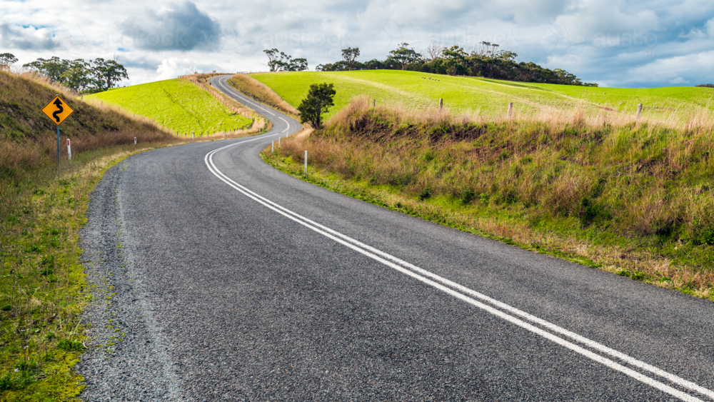 Winding road through Adelaide Hills farms during winter season - Australian Stock Image