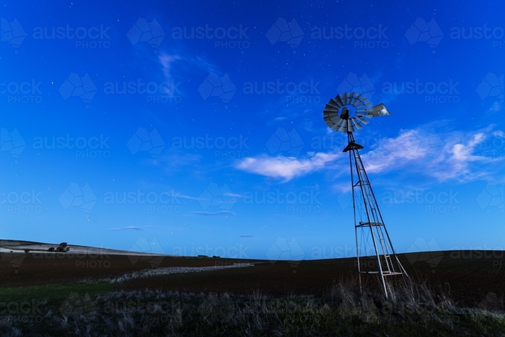 Windmill against a blue night sky - Australian Stock Image