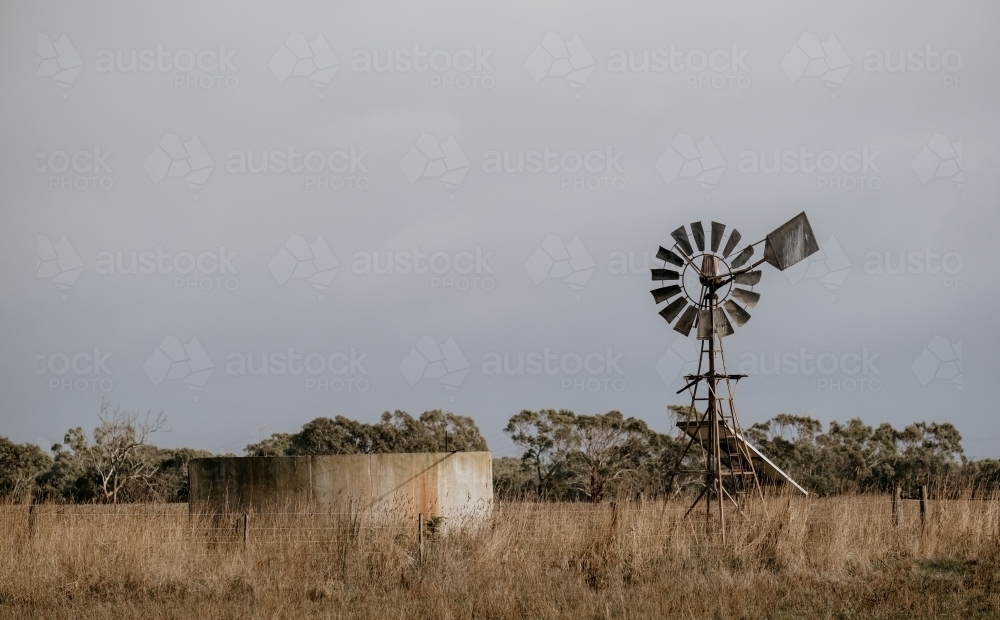 Windmill and water tank on a farm. - Australian Stock Image