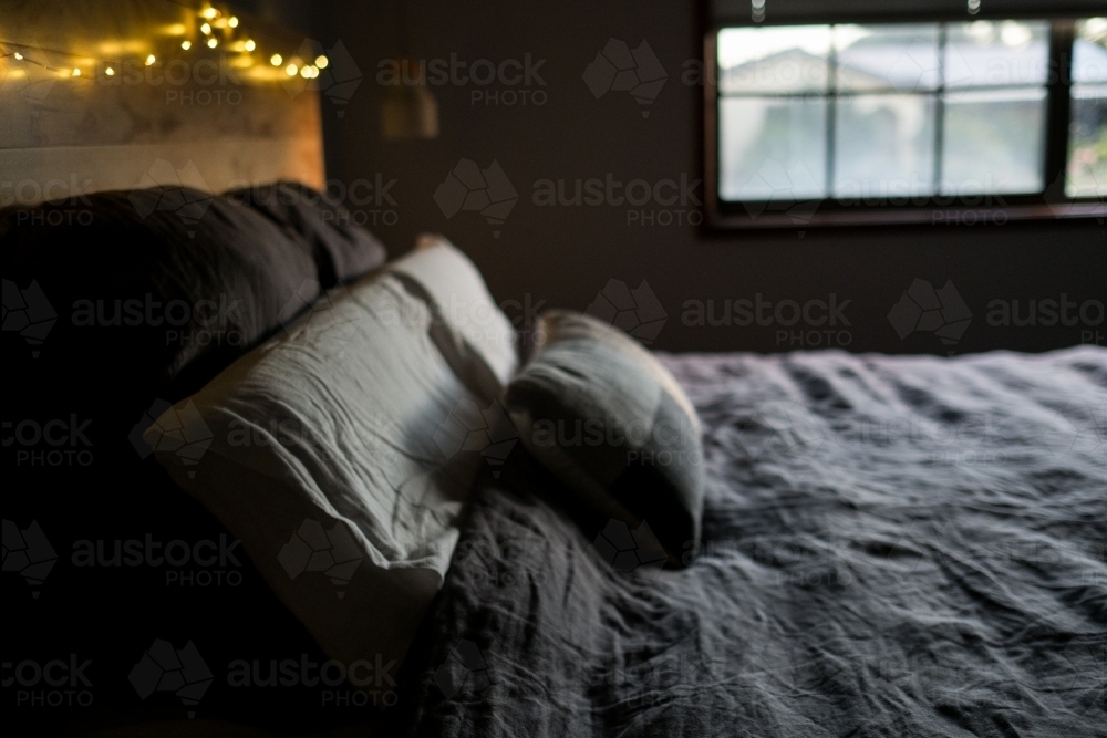Window light on linen bedspread - Australian Stock Image