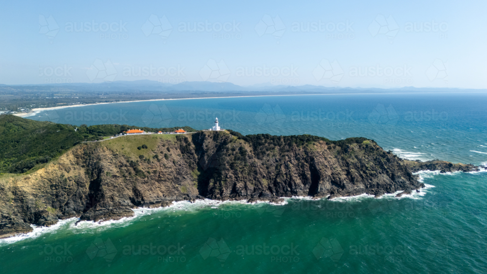 Windswept headland above rugged coastline with steep cliffs - Australian Stock Image