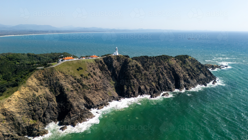 Windswept headland above rugged coastline with steep cliffs. - Australian Stock Image