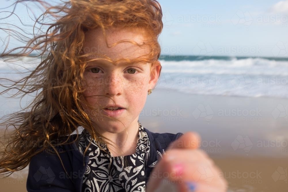 Windswept young girl at the beach - Australian Stock Image