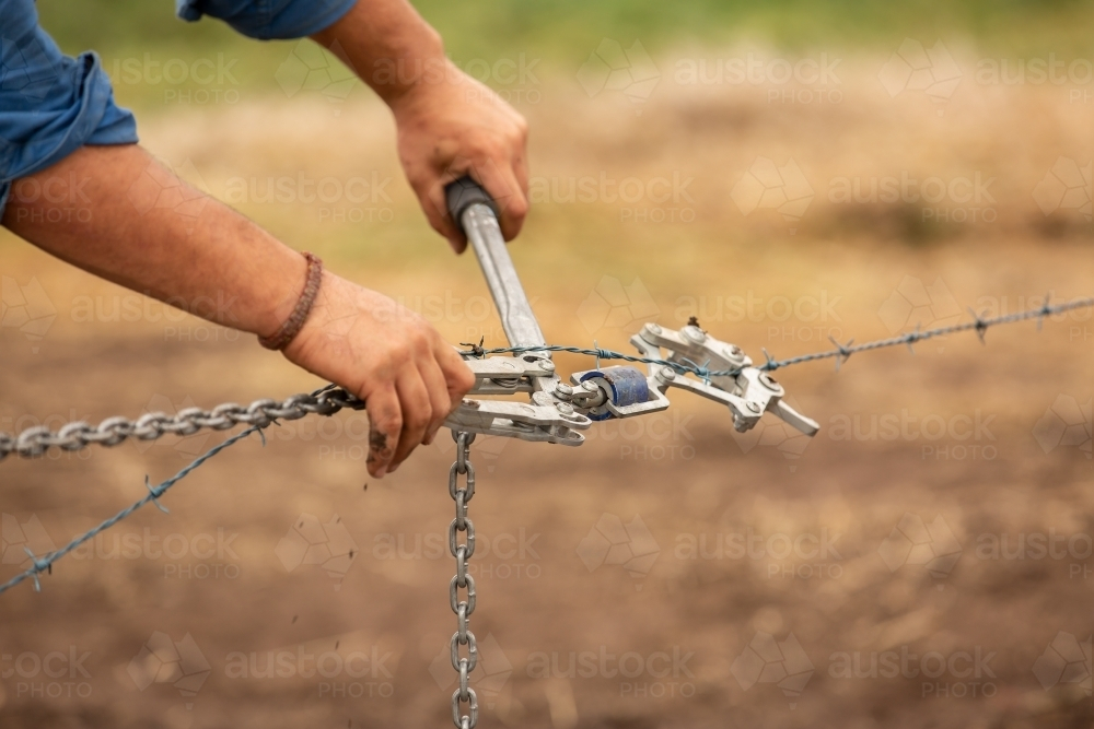 Wire strainers being used to build a new fence - Australian Stock Image