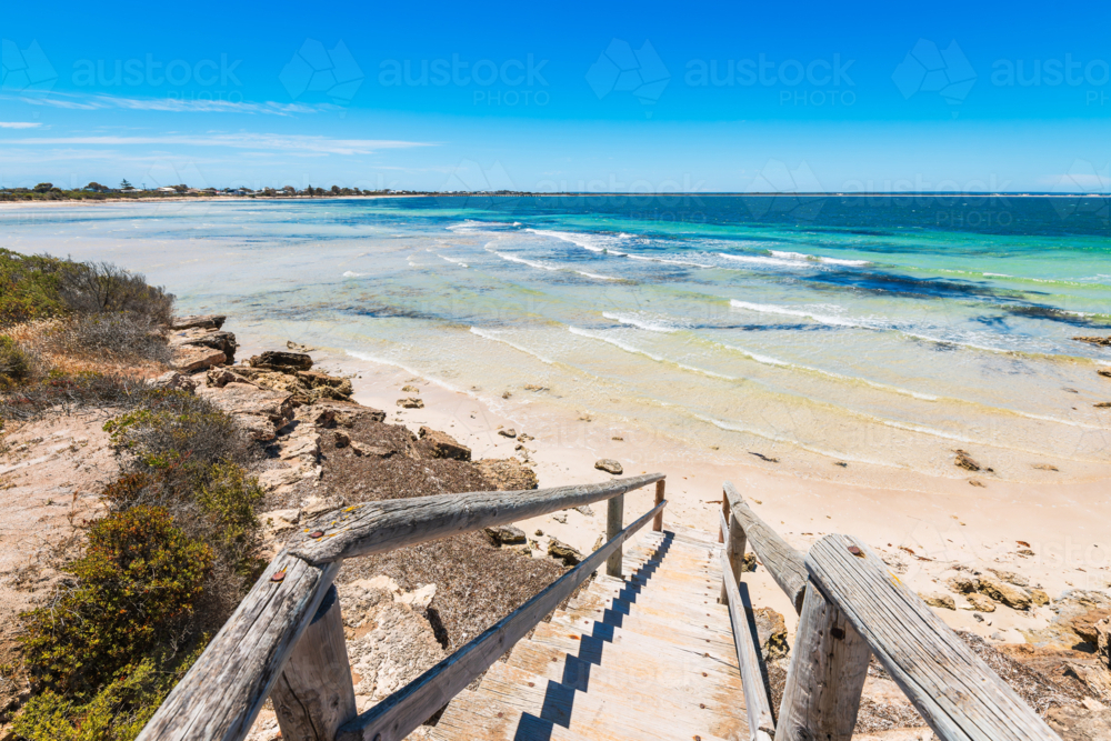Woden boardwalk with seaside landscape of Penguin Point Bay under blue sky, on a bright day - Australian Stock Image