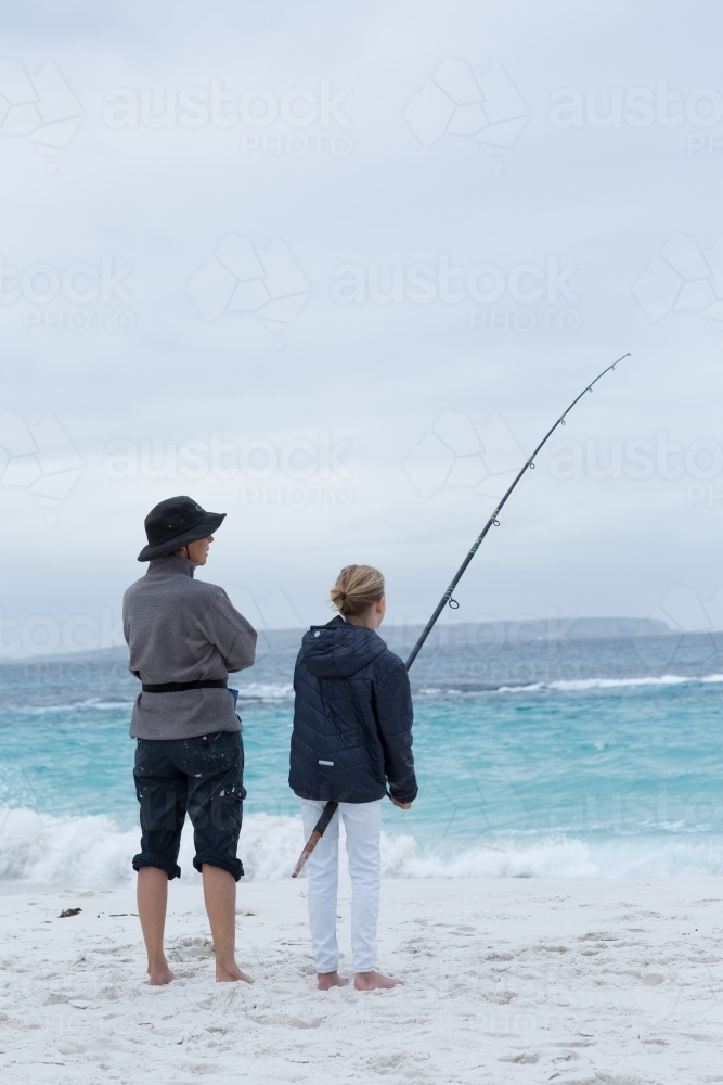 Woman and child fishing on the beach - Australian Stock Image