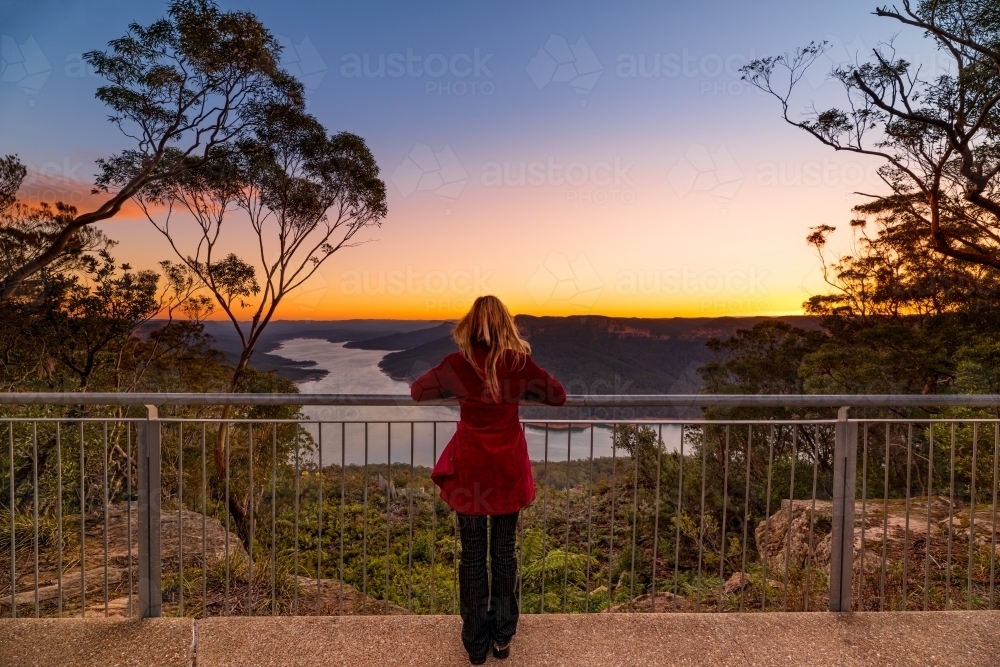 Woman at lookout watching the sunset at Burragorang, Nattai Australia - Australian Stock Image