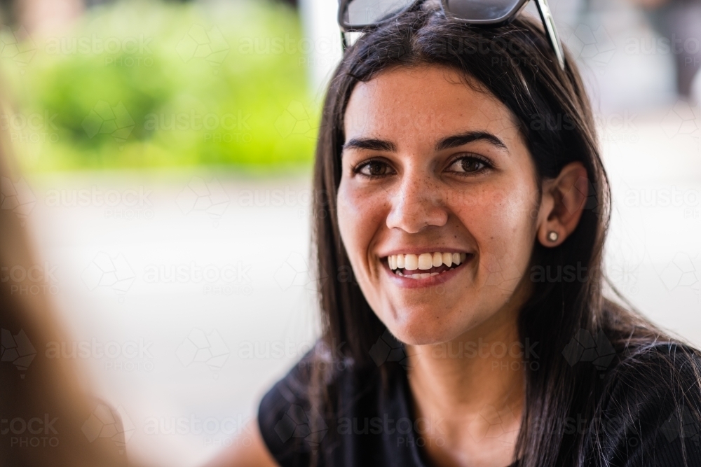 woman chatting with friend in a cafe - Australian Stock Image