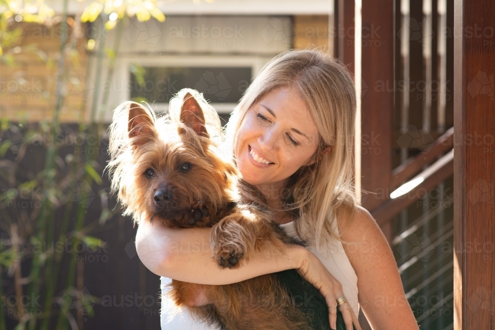 woman cuddling with her dog - Australian Stock Image